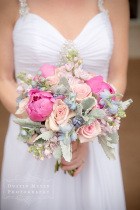 A stunning and unique bridal bouquet with pink, green, and fuchsia colors elegantly created by Austin wedding and bridal florist Verbena Floral Design